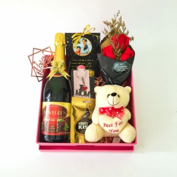 Adorable Birthday gift hamper with sparkling grape juice, teddy bear and a sweet greetings.