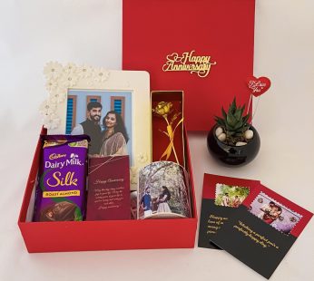Elegant anniversary gift hamper with a Dairy Milk , Mug and blissful greetings