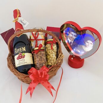 Delightful anniversary gift hamper with a Wine , Chocolate and blissful greetings