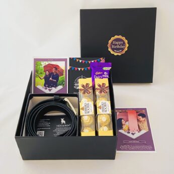 Elegant Birthday gift hamper with Stylish belt, Chocolate and a sweet greetings.