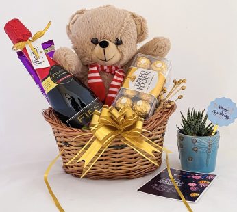 Delightful Birthday gift hamper with Tasty wine, teddy bear, and a sweet greetings.