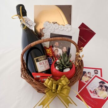 Elegant anniversary gift hamper with a Wine, Frame and blissful greetings