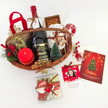 Chic Christmas Gift Basket Filled With Mini Christmas Tree, Sparkling Wine, Scrumptious Cakes, and More