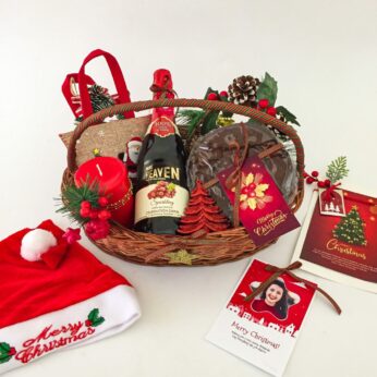 Exciting happy holidays gift basket with sparkling grape juice, rich plum cake, chocolate bag and may items