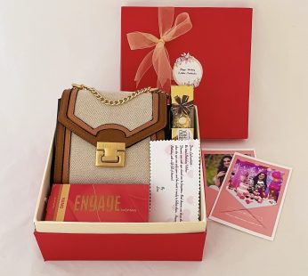 Delightful Birthday gift hamper with Sling bag, Perfume and a sweet greetings.