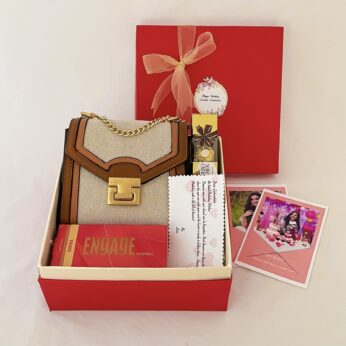 Delightful Birthday gift hamper with Sling bag, Perfume and a sweet greetings.