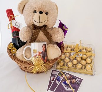 A delightful happy birthday gift for sister with grape juice, a teddy, and chocolates