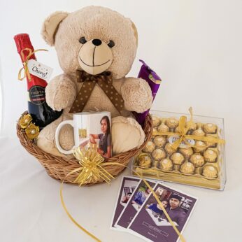 A delightful happy birthday gift for sister with grape juice, a teddy, and chocolates