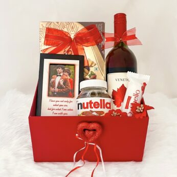 Amorous gift hamper for valentine’s day with chocolates, wine, and picture frame