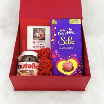 Valentine’s Day gift box with valentine day chocolate dairy milk , flowers, and more