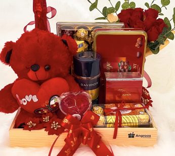 Luxury Anniversary gift hamper with Elegant Teddy, Chocolates, David Coffee, Perfume, Artificial Flowers And Cards
