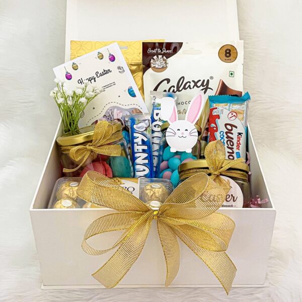 A beautifully crafted Easter hamper, brimming with goodies such as chocolates, candies, and other delightful surprises.