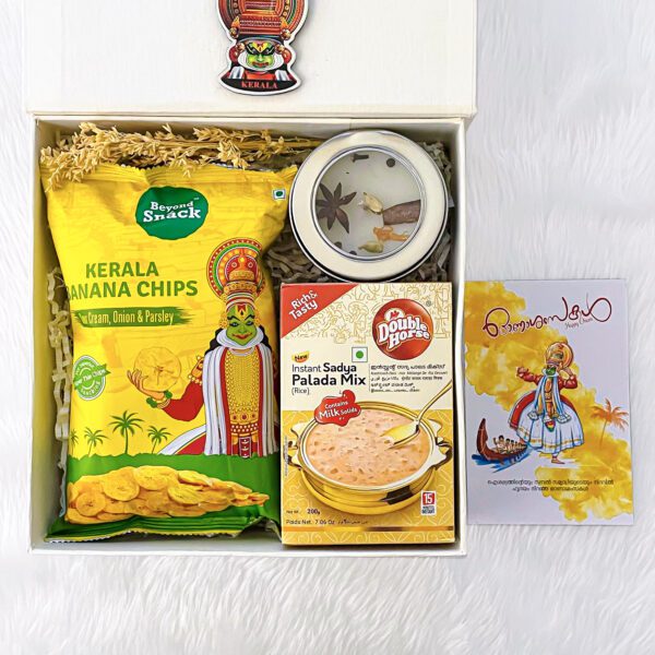 A beautifully curated gift hamper from Angroos, featuring Kerala's finest delicacies such as banana chips, savory snacks, and sweets."