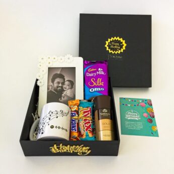 staggering birthday gift box for him filled with chocolates, perfume, and greetings