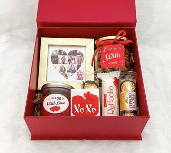 A special anniversary gift combo for her contains chocolates, a Candle, and greetings