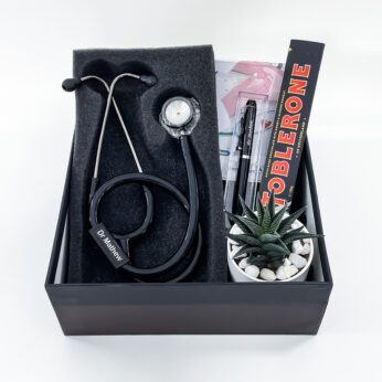 Simple & best gifts for doctors embellished with a stethoscope, desk plant, and notepad