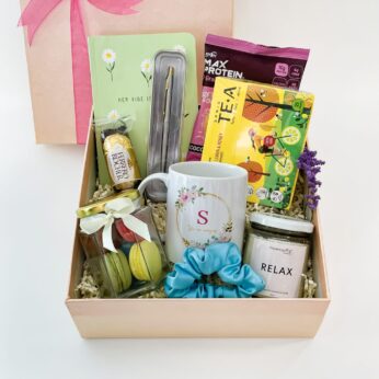 Alluring online rakhi gift for sister filled with chocolates, a pocket diary, and a mug