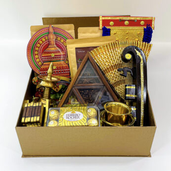 Grandeur Onam gift hamper decorated with a Nettipattam, Nilavilakku, udayada, and more