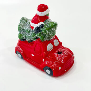 ceramic Santa Claus in a vintage red car for your Cheerful decorations