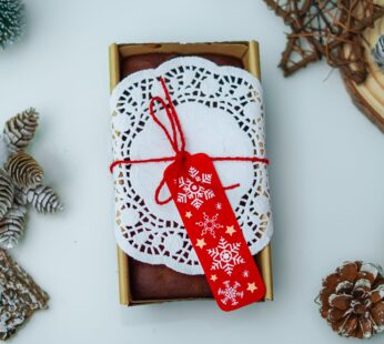 Experience Festive Joy with Our Christmas Loaf Cake, Adorned with a Red Christmas Tag ( 300 gm)