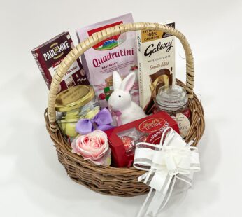 Personalized Easter Baskets embellished with a toy rabbit, scented candle, and chocolates