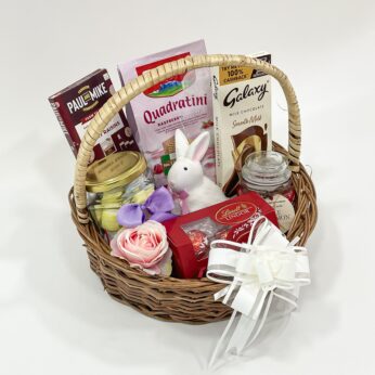 Personalized Easter Baskets embellished with a toy rabbit, scented candle, and chocolates
