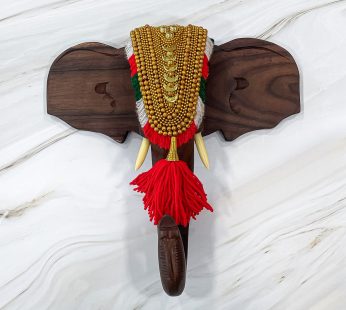 Spice up your living area with this 13-inch Rosewood elephant head with nettipattam wall decor.