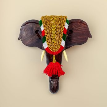 Spice up your living area with this 12-inch Rosewood elephant head with nettipattam wall decor.